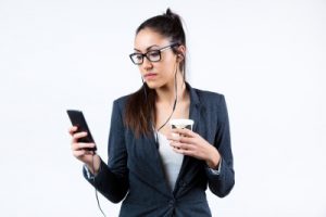 Business Women using her mobile phone and drinking coffee