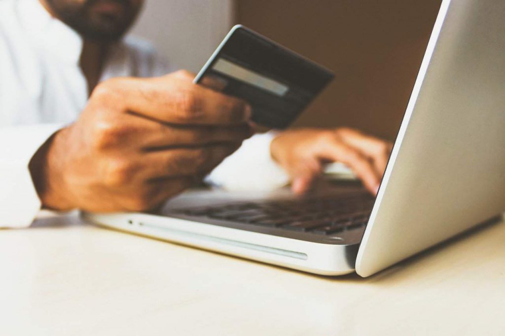 Man making an online credit card payment. One method of how hackers attack small businesses.