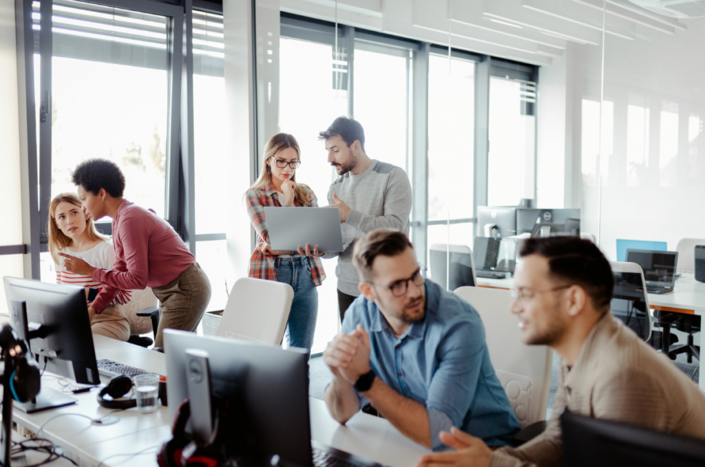 Casual work colleagues freely chatting in a modern office