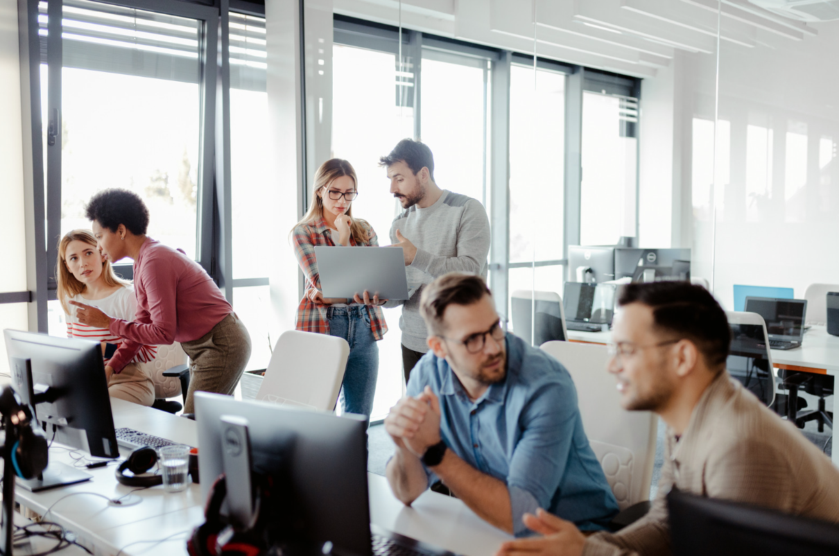 Casual work colleagues freely chatting in a modern office