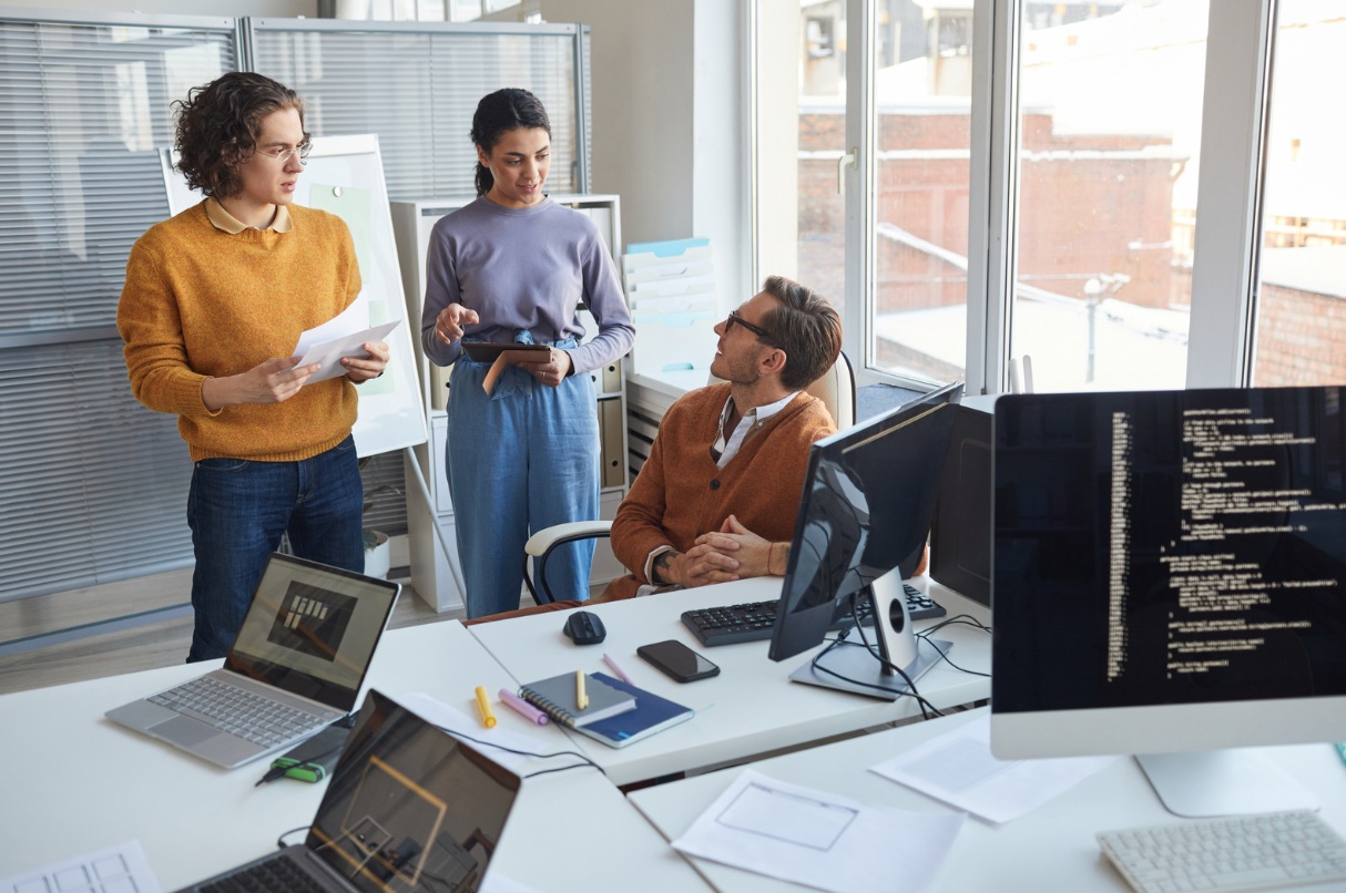 Three work colleagues discussing in an office