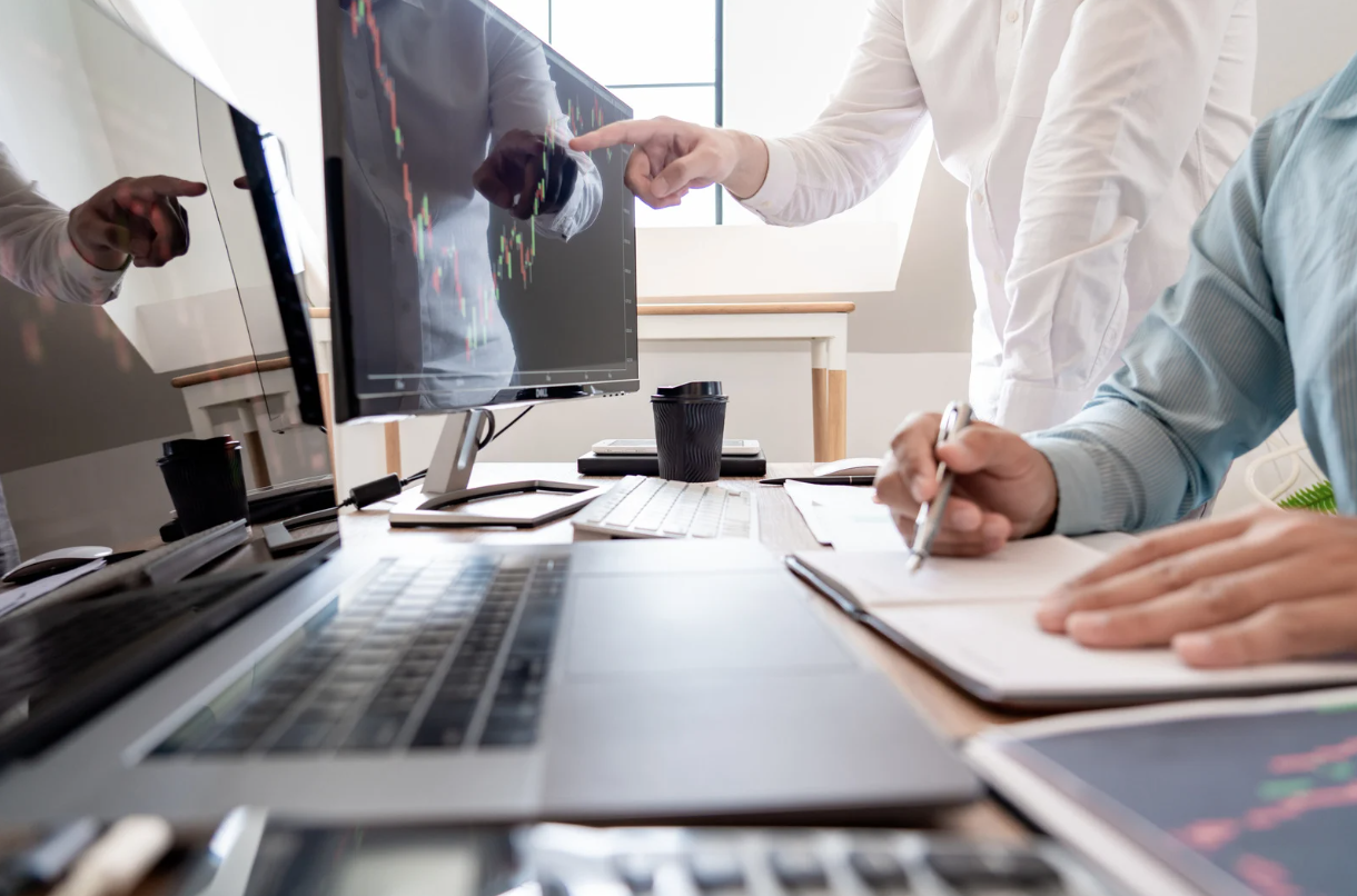 Two work colleagues analysing computer screen