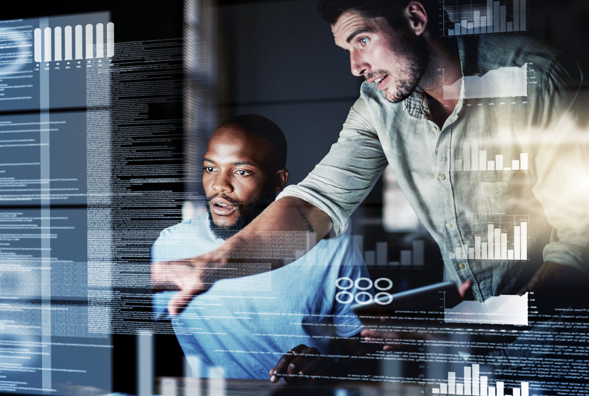 work colleague advising another on a computer