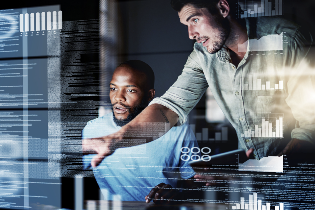 office worker advising colleague infront of computer screen