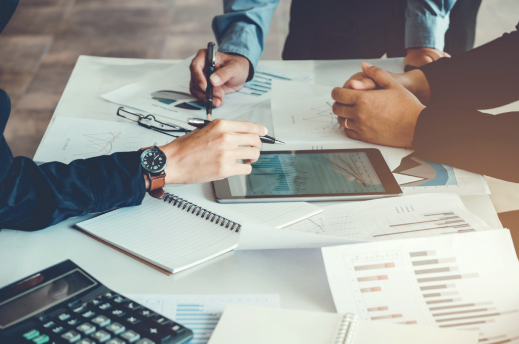 Three technology workers planning analysis on a tablet