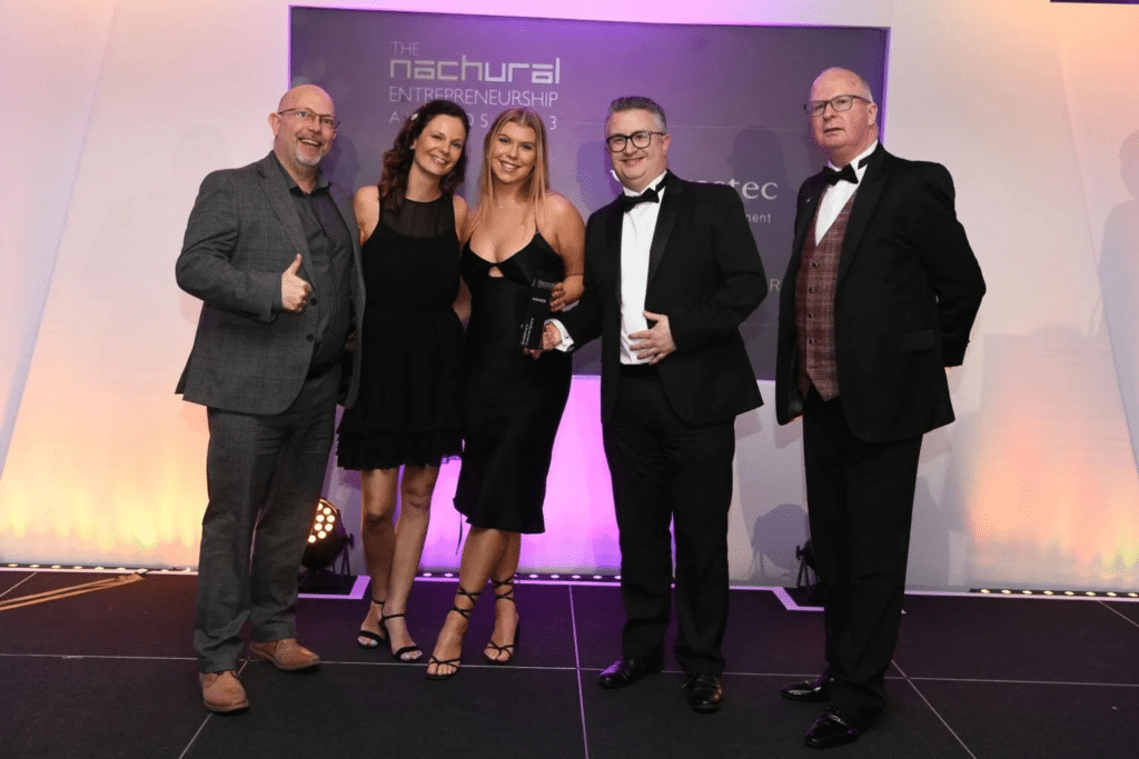 Smartly-dressed Your IT Department staff posing for a photo at an awards gala.