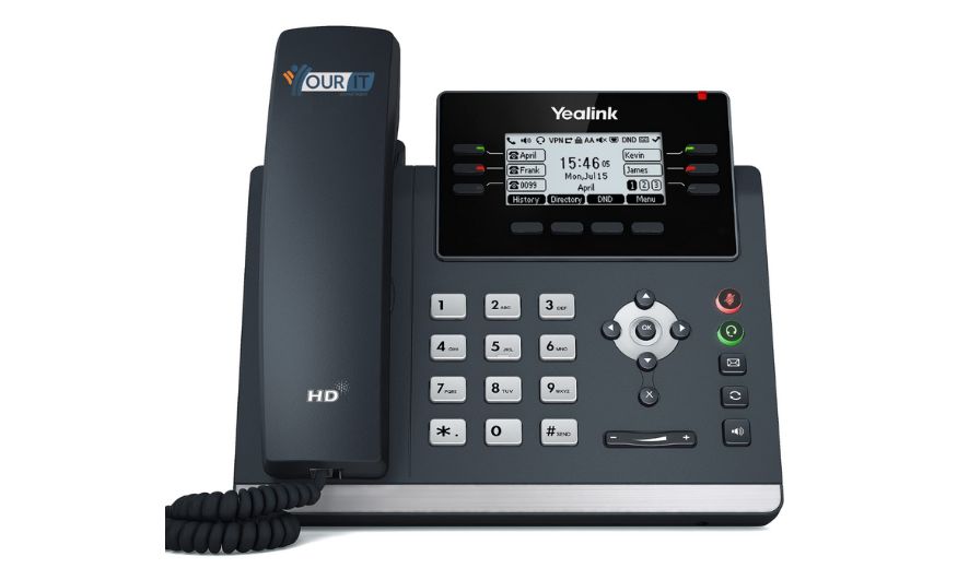 Yealink VoIP desk phone with colour display and handset, used by UK small businesses for cloud-based telephony as part of the PSTN shutdown VoIP transition